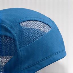 Close-up of a hat with breathable mesh panels and ventilation holes, showing air flow.